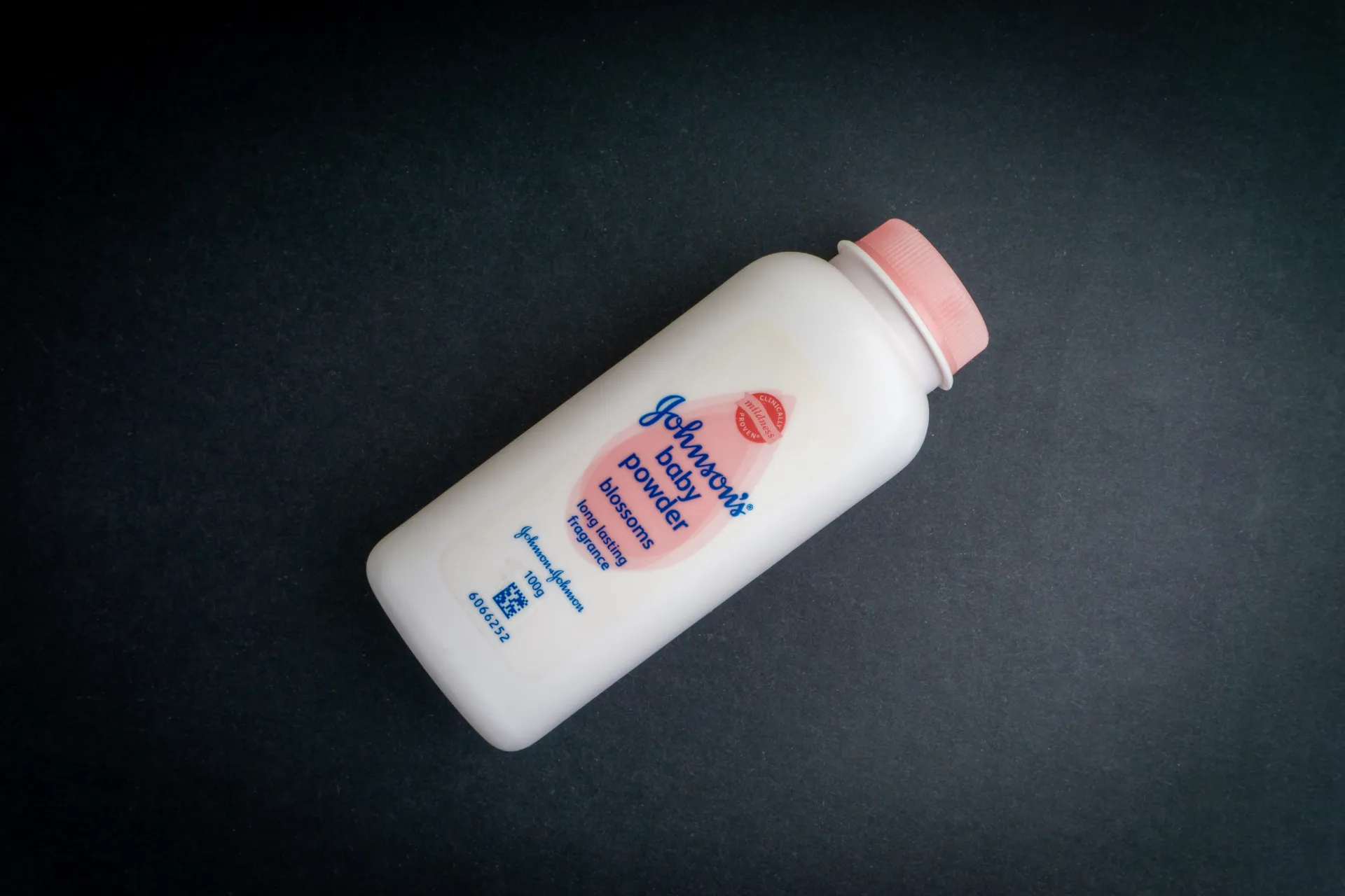 Jonson's Baby Powder bottle on dark gray background