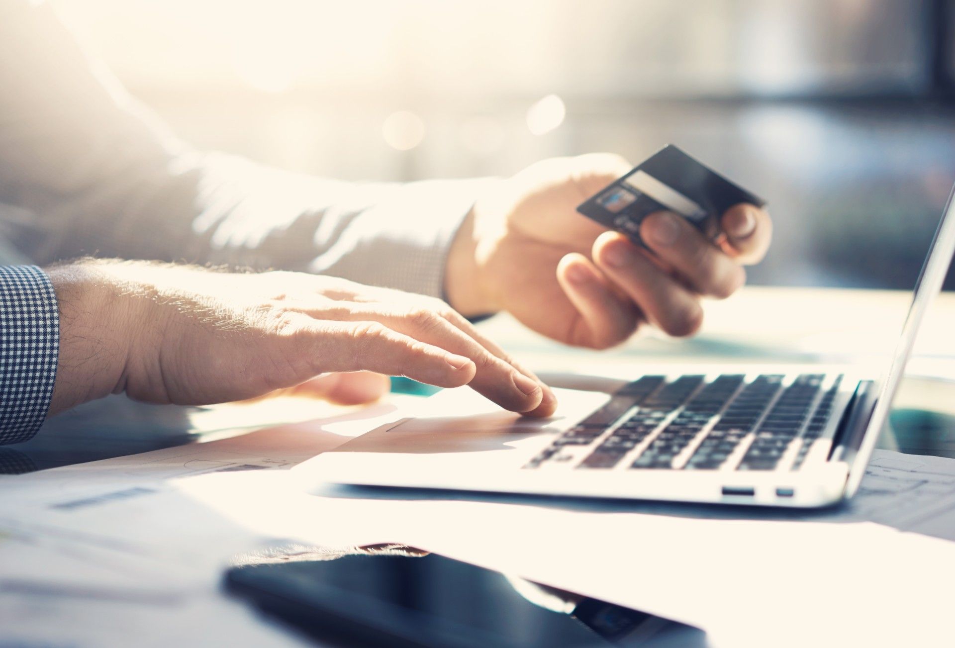 Man puts credit card information into laptop