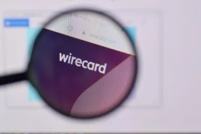 Wirecard logo on screen behind magnifying glass