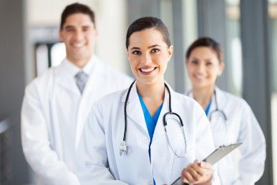 Three doctors, female doctor in foreground - pay rises