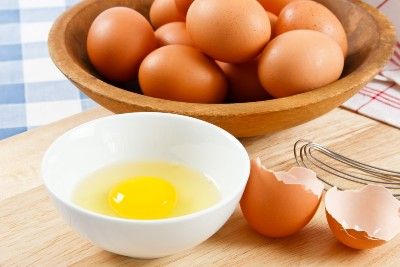 Bowl of eggs with one broken egg in foreground - UK salmonella outbreak