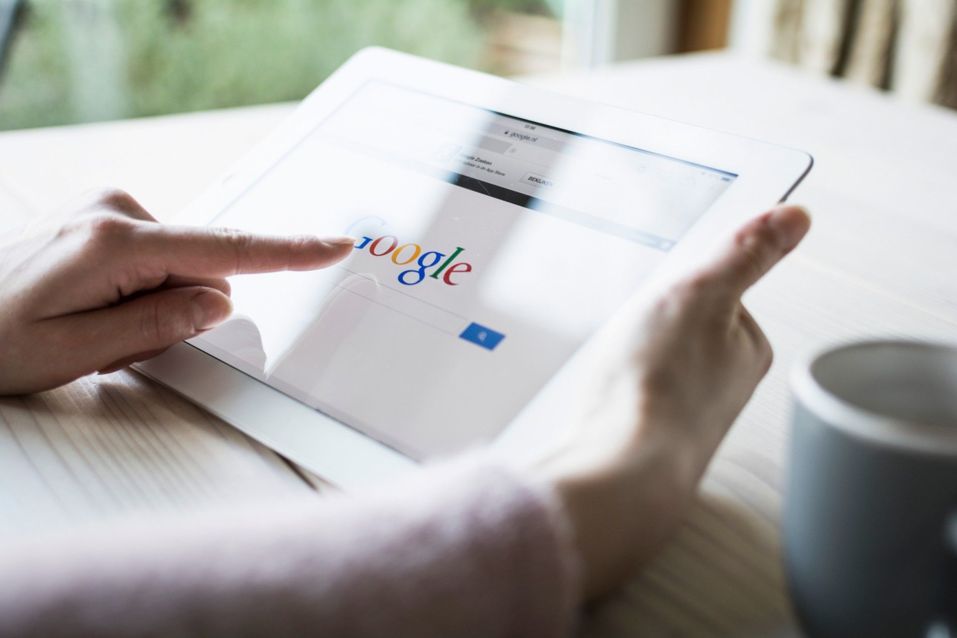 Woman uses Google search on tablet - tracking cookies class action