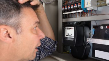 Man looks astonished while looking at electricity meter - British Gas