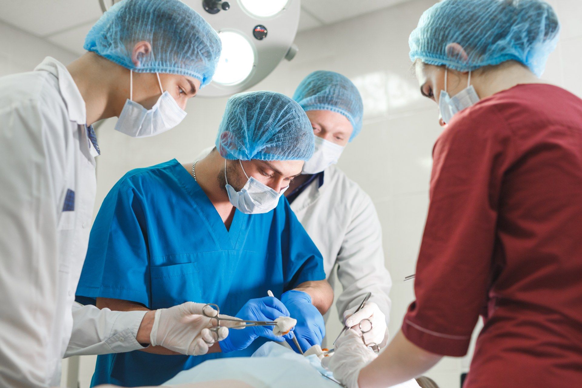 Doctors perform surgery in a hospital - nhs masks