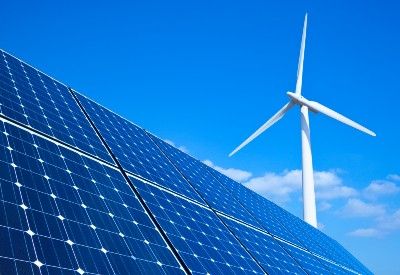 Windmill and solar panel against partly cloudy blue sky - Bulb