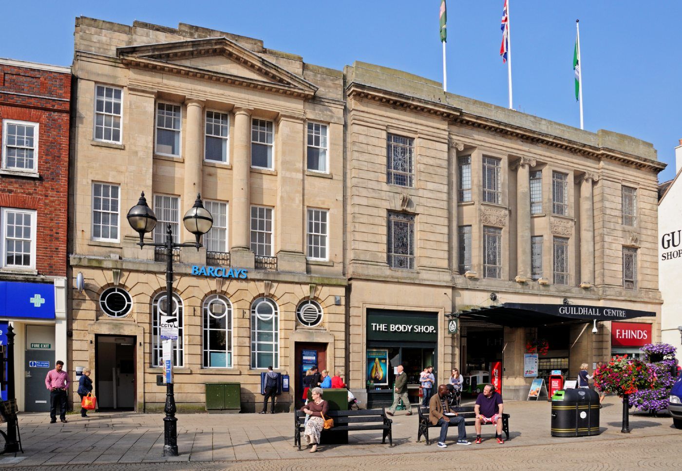 People walk near a Barclays bank - british bank accounts