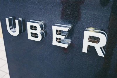 An Uber sign at a pickup point - London license