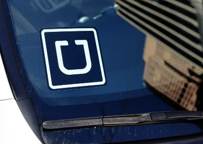 An Uber decal is shown in the corner of a car windshield - london licence