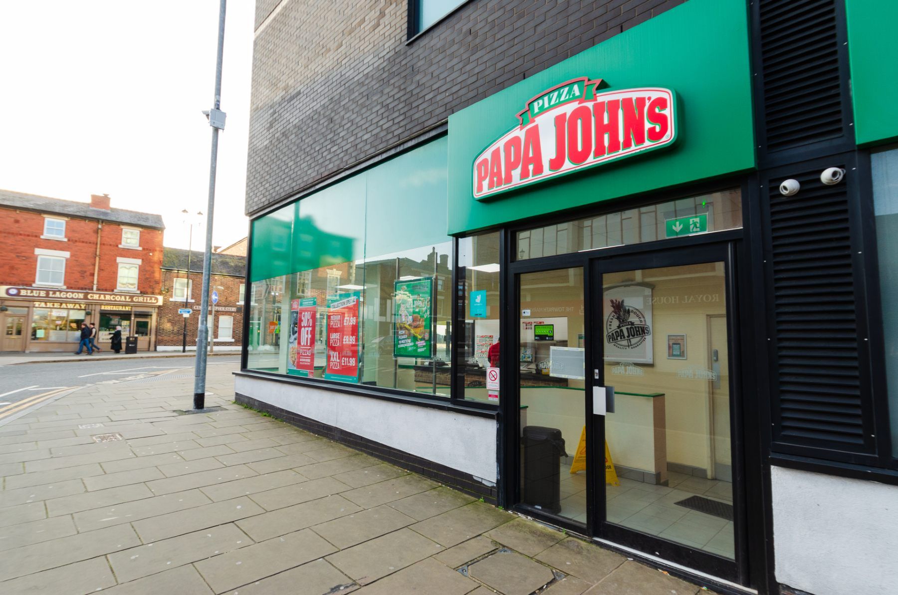 A Papa John's storefront - eat out to help out fraud