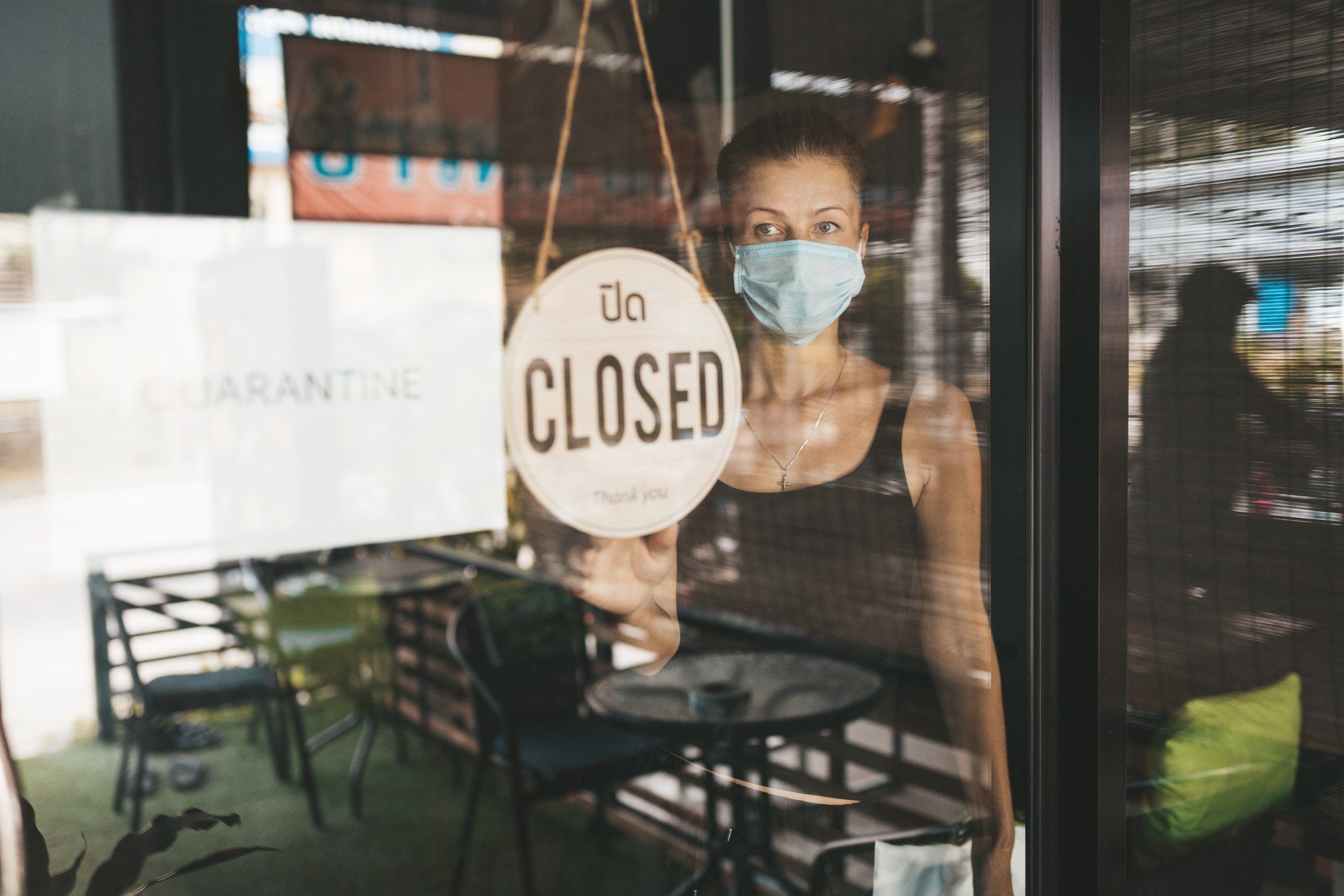 woman closing store regarding the business support scheme 