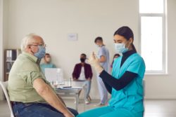 Senior getting COVID-19 vaccine regarding UK approval 