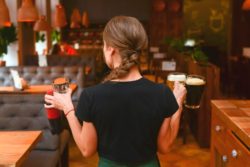 Bartender with beers at pub regarding Marston's takeover