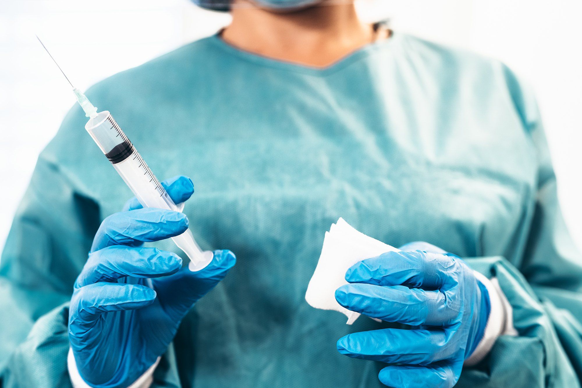 Doctor holding syringe regarding the COVID-19 vaccine and it's legal indemnity 