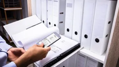 Assesor taking phot of documents regarding Capita data breach