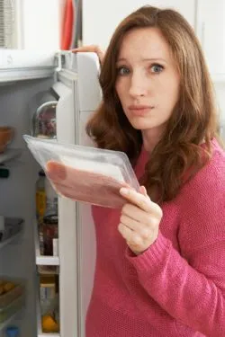Woman throwing out meat regarding recall 