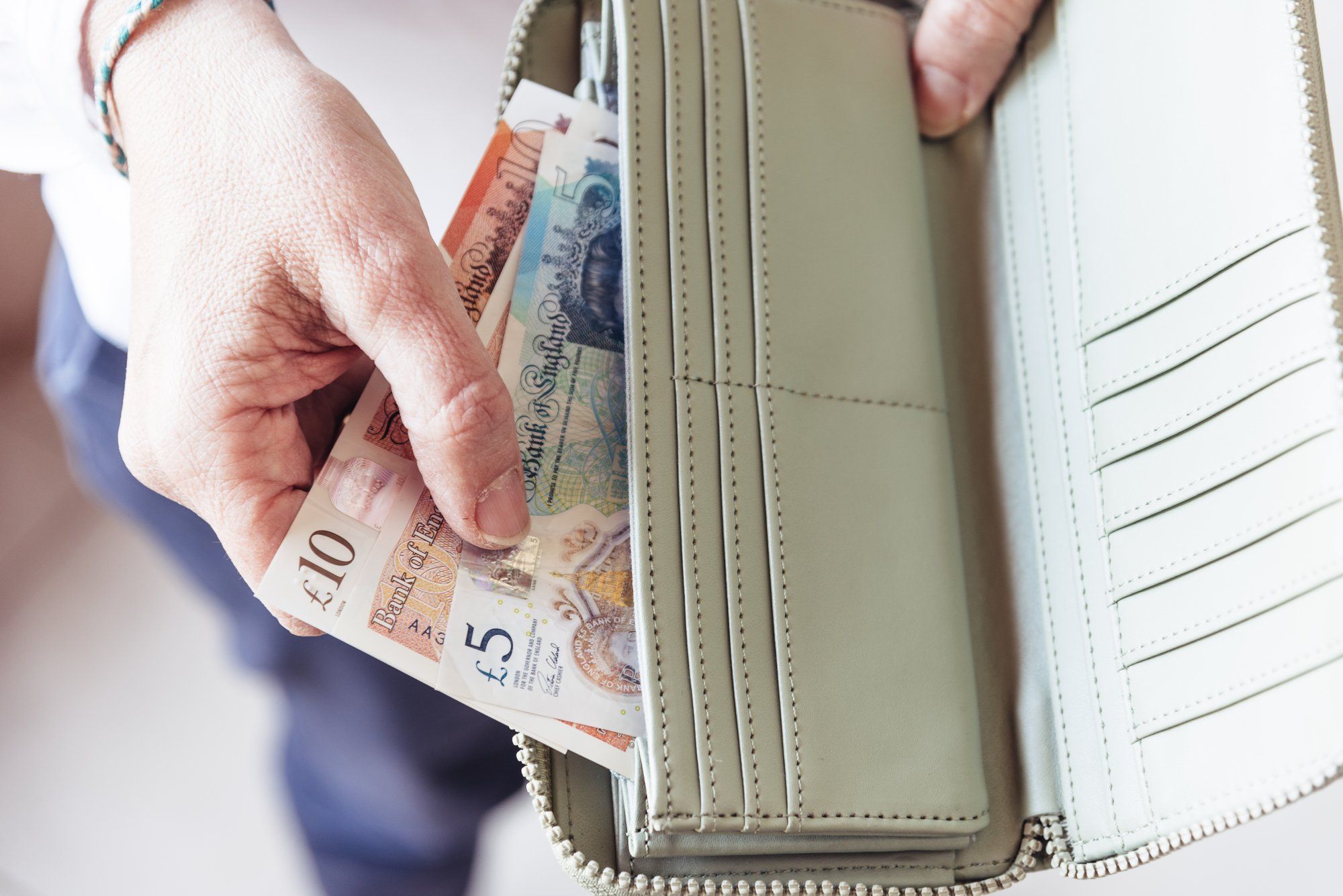 Employee holding money regarding companies short-changing workers