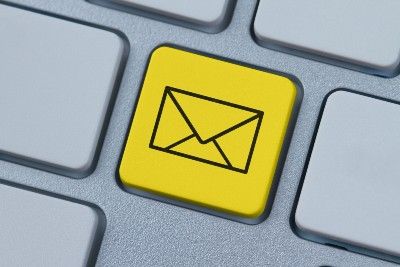 A yellow computer keyboard key shows a black email icon - watford community housing