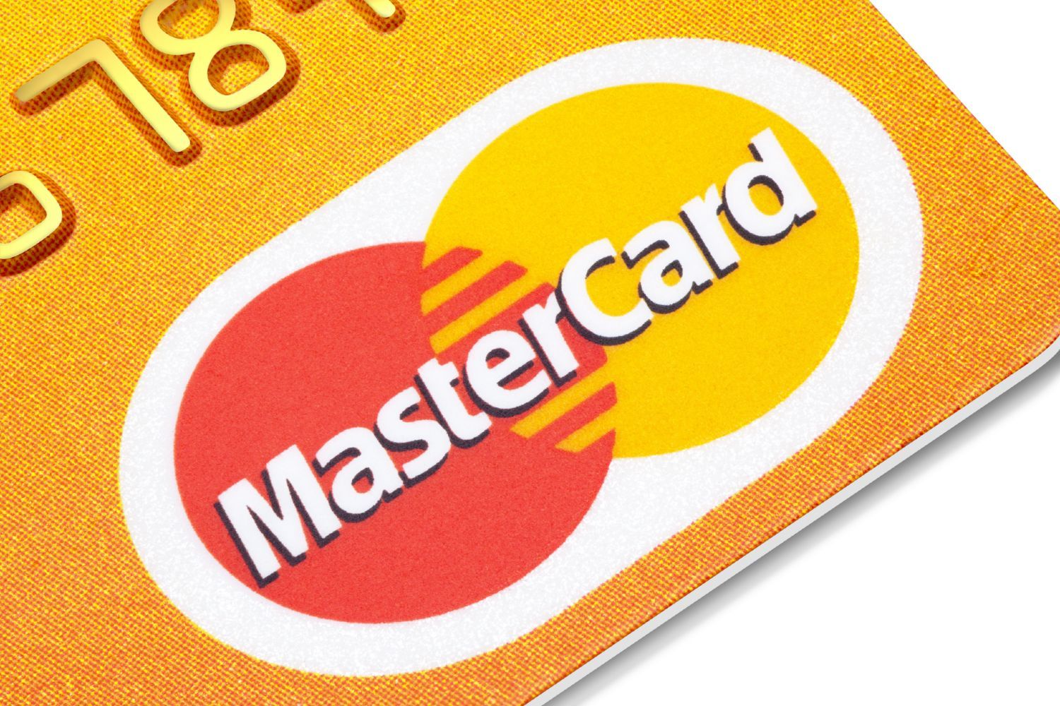 Mastercard logo on an orange credit card - mastercard class action lawsuit