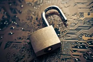 An open copper lock lies on top of a copper circuit board - transform hospital group