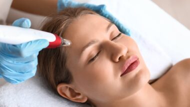 Young woman undergoing procedure of bb glow treatment in beauty salon