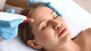 Young woman undergoing procedure of bb glow treatment in beauty salon