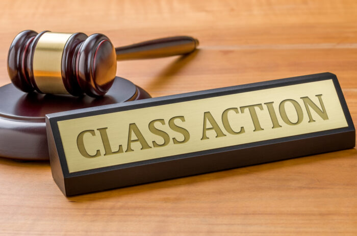 A gavel and a name plate with the engraving Class action.