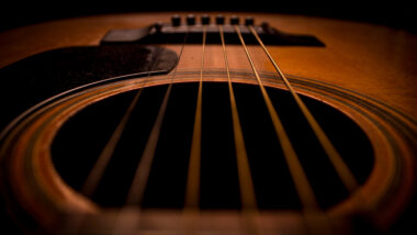 Closeup image of an acoustic guitar.