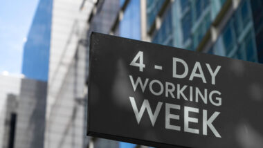 Sign on a building that reads "4-Day Working Week"