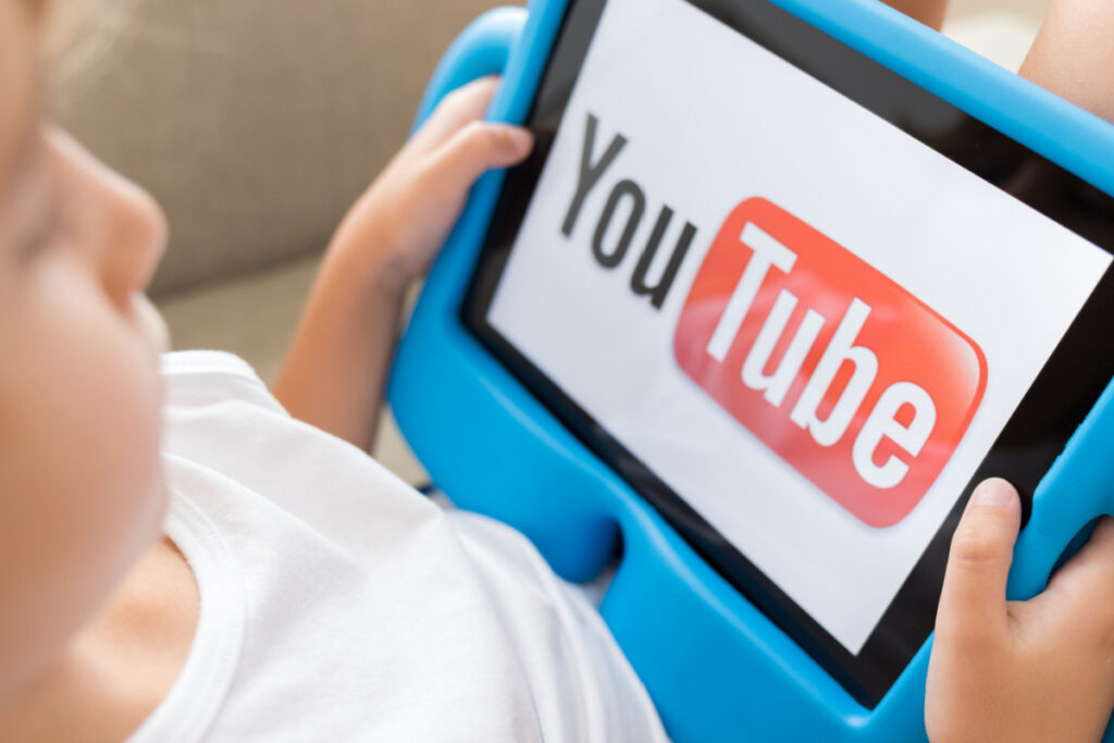 Little girl watching YouTube on tablet