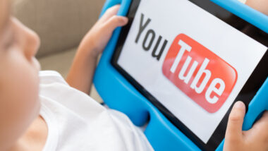 Little girl watching YouTube on tablet