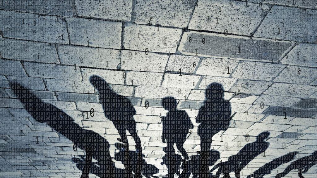 Shadows of teens with binary code floating around