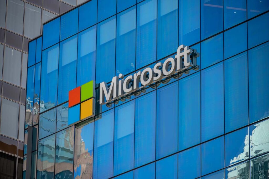 Close up of Microsoft signage on a building, representing the Microsoft and OpenAI antitrust review.