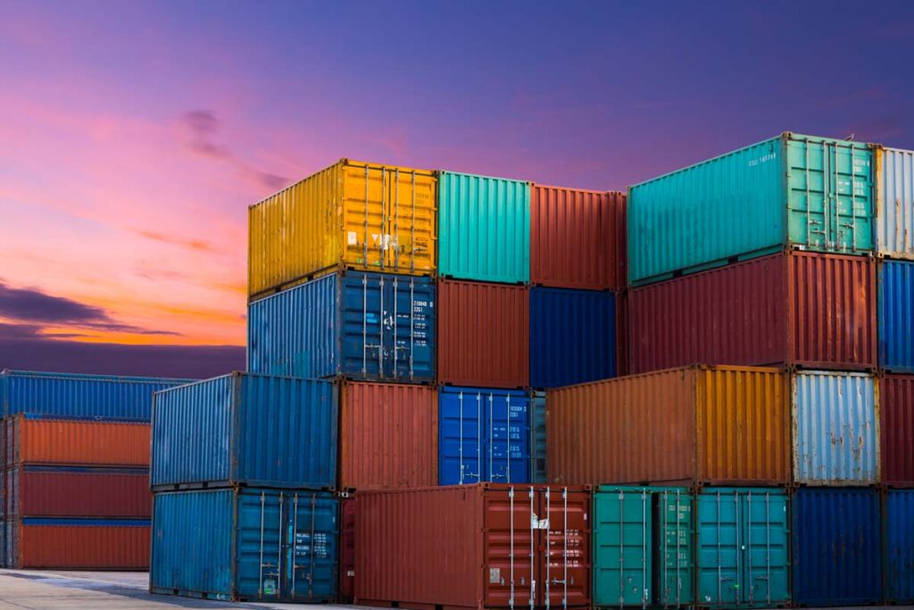 Shipping containers in an industrial yard, representing the UK levy.