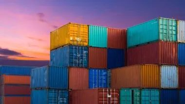 Shipping containers in an industrial yard, representing the UK levy.