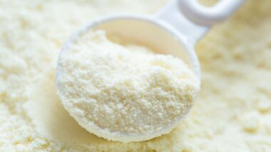 Close up of infant powder formula and a spoon, representing the Nutramigen infant formula recall.