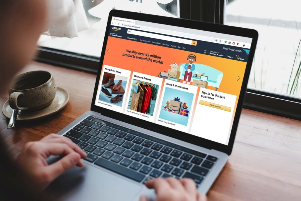 Close up of a woman scrolling on the Amazon homepage on a laptop, representing the Amazon class action.