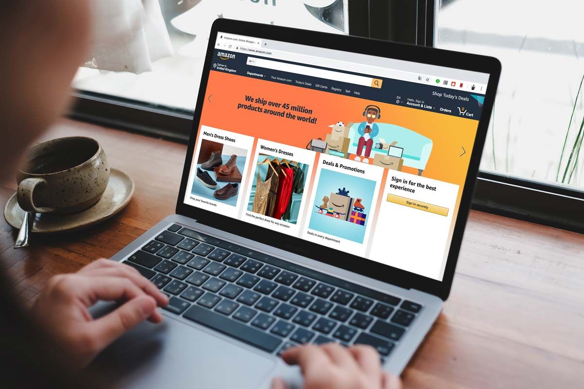 Close up of a woman scrolling on the Amazon homepage on a laptop, representing the Amazon class action.